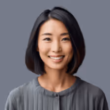 Portrait of a smiling Asian woman with straight black hair wearing a grey top against a grey background.
